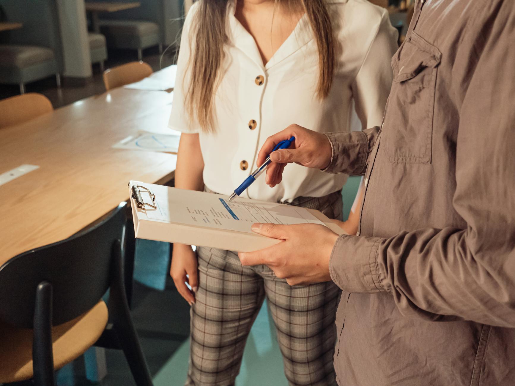a person holding a binder with a document